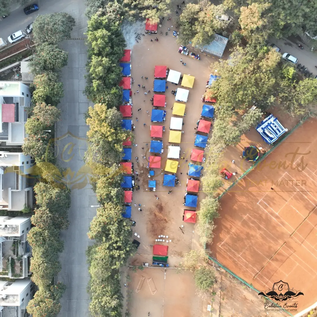 Aerial view of coloured canopies on the grounds of Gowthami Enclave